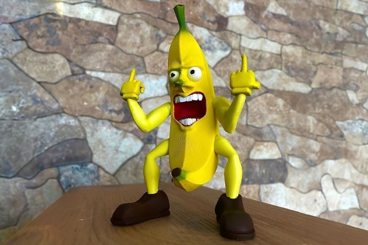 Figurine drôle banane doigt d'honneur